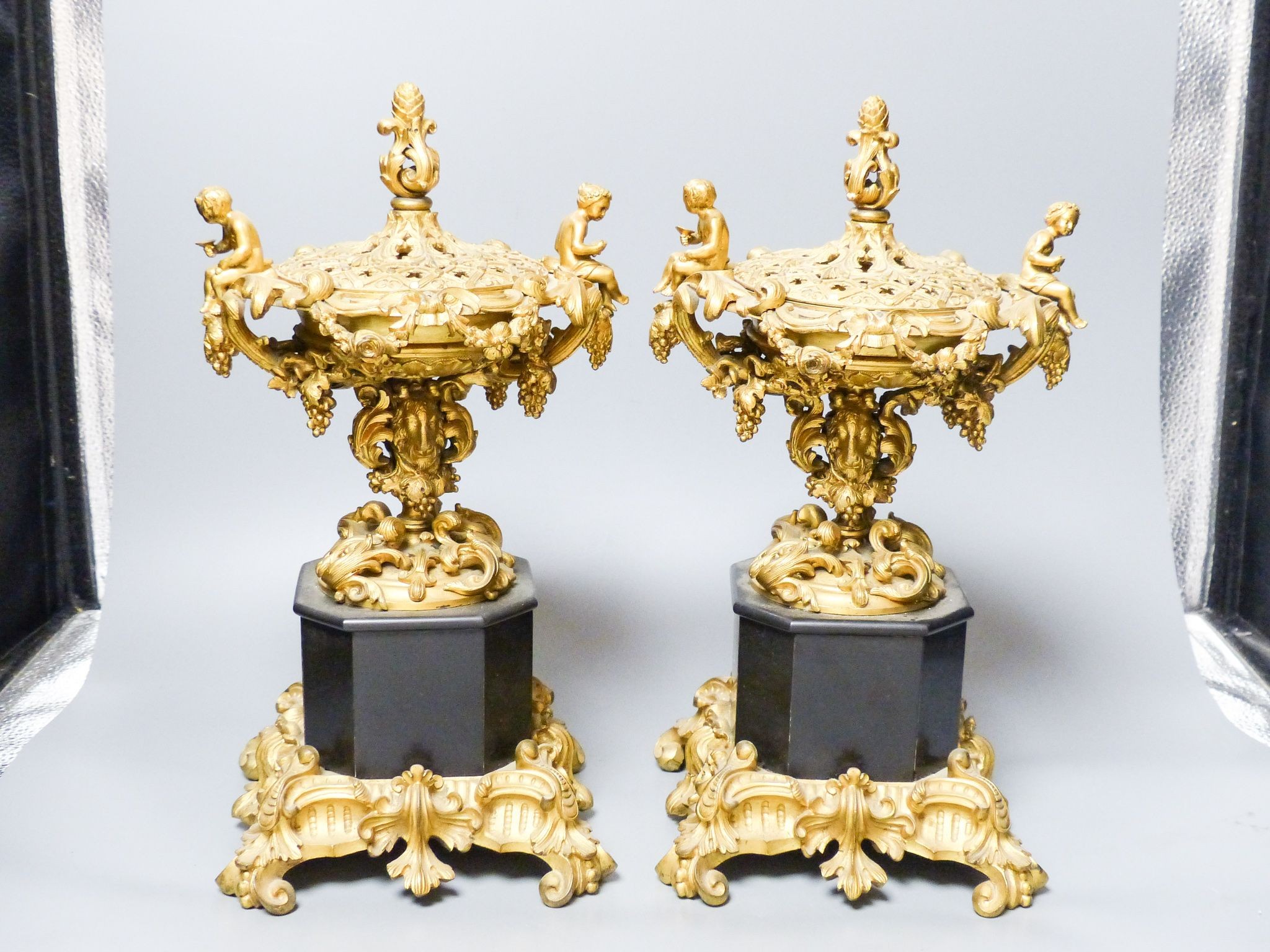 A pair of 19th century French ormolu and black marble pot pourri and covers, 34.5 cm high